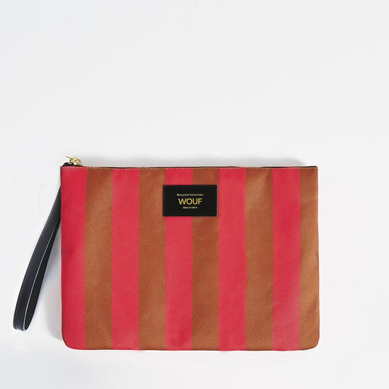 Bolso de mano tipo sobre de gran tamaño con estampado de rayas en tonos naranja y rosa, con cierre de cremallera superior y etiqueta de cuero de Wouf.