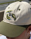 Gorra Pementos de NWHR, 6 paneles en algodón orgánico con bordado frontal y cierre ajustable.
