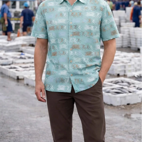 Camisa de hombre de manga corta con estampado de nécoras (cangrejos) en tonos azules y tierra, botones de madera de olivo y tejido fluido de algodón orgánico.