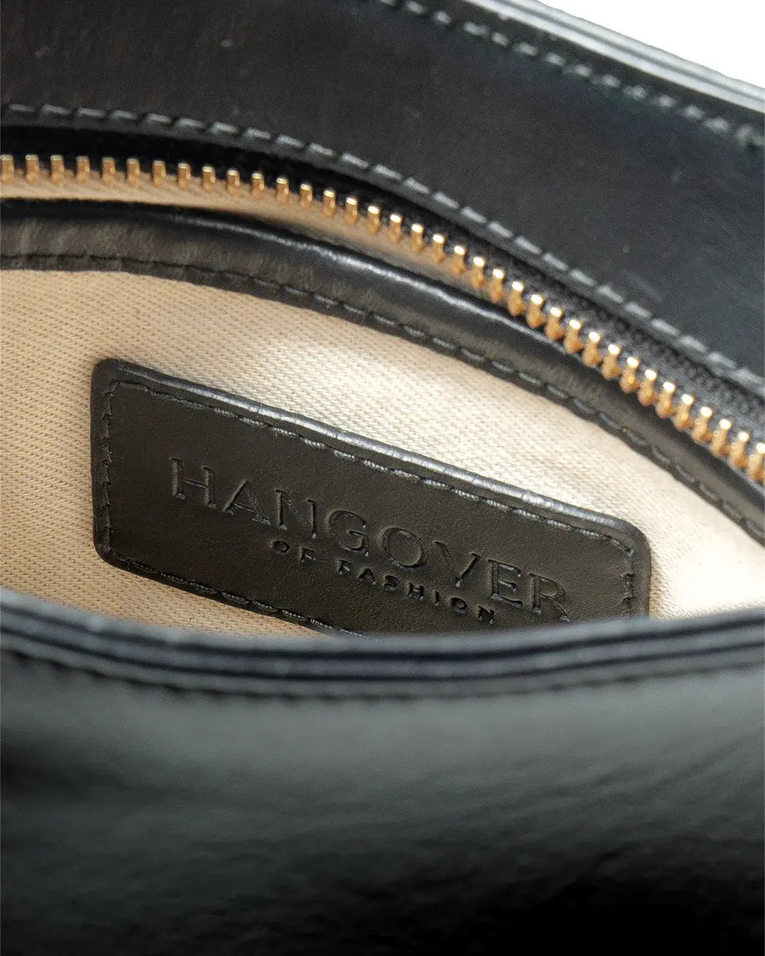 Bolso pequeño estructurado de piel napa negra con asa ajustable y diseño minimalista de la marca Hangover of Fashion, fabricado artesanalmente en España.