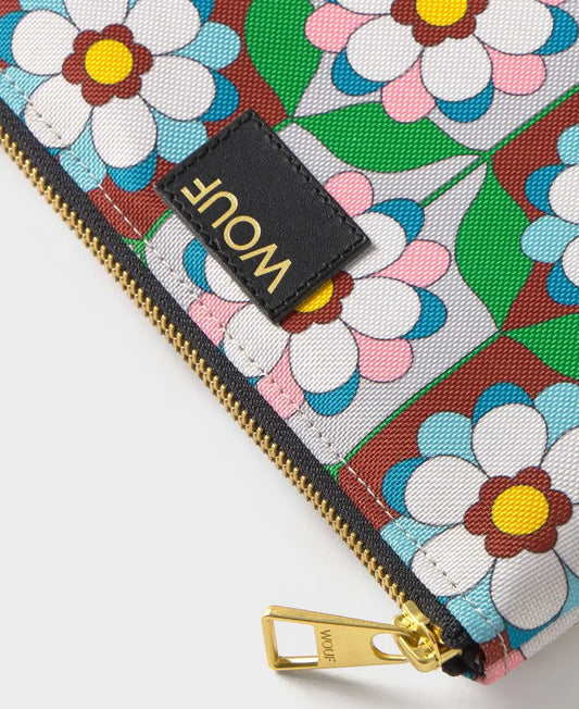 Pequeña funda plana con estampado geométrico multicolor, cierre de cremallera superior y etiqueta de cuero reciclado, modelo Kaleido Pouch de Wouf.