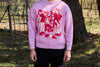 Jersey de punto grueso en color rosa con textura de relieve, cuello redondo y terminaciones acanaladas en puños y cintura, de la marca NWHR.
