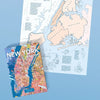 Puzzle de 1000 piezas que muestra un mapa ilustrado de la gastronomía de Nueva York, con dibujos de platos típicos, cócteles y barrios emblemáticos sobre fondo colorido.