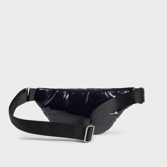 Riñonera negra con acabado brillante de la colección Nuit de Wouf, con correa ajustable, cremallera superior y etiqueta de cuero reciclado con logo frontal.