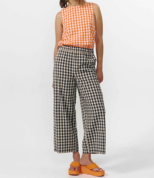 Pantalón culotte de pernera ancha con estampado de cuadros en tonos grises y blancos, talle alto con cintura elástica y bolsillos laterales, hecho en algodón orgánico.