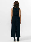 Pantalón de corte culotte en color negro con pernera ancha y corta, talle alto con cintura elástica y bolsillos laterales, fabricado en algodón orgánico.