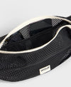 Bolso bandolera de color negro puro, de diseño estructurado con correa cruzada ajustable de algodón, cremallera superior y etiqueta de silicona, modelo Onyx de Wouf.