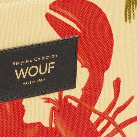 Funda acolchada para portátil  con estampado tropical de aves y flores, cierre de cremallera y etiqueta de cuero reciclado de Wouf.